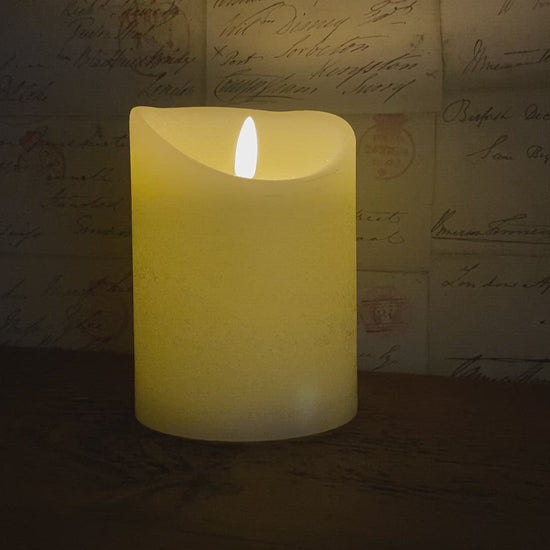 video of the cream led candle with it's flickering flame wick.